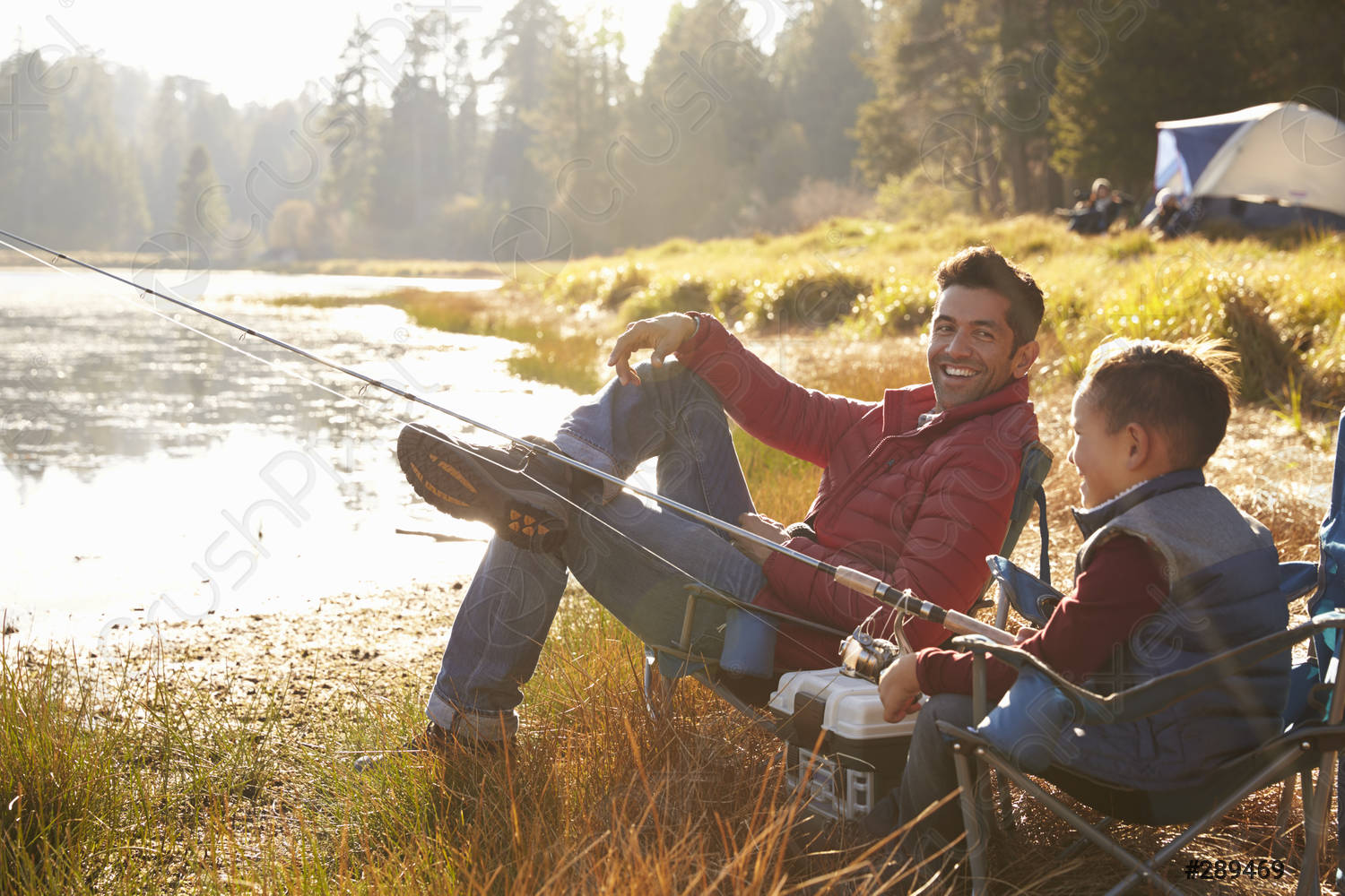 father and son fishing on a lake